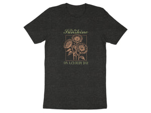 Dark t-shirt with sketch of three sunflowers and text "Be the Sunshine ON A CLOUDY DAY".