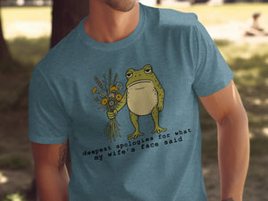 T-shirt with frog holding flowers and text "deepest apologies for what my wife's face said".