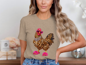 Chicken wearing sunglasses, necklace, and fuzzy slippers on a taupe t-shirt.