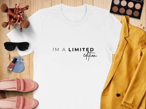 White t-shirt with black text "I'M A LIMITED edition." Surrounded by accessories.