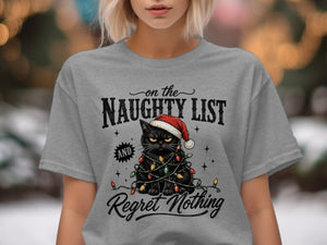 A grey t-shirt featuring a grumpy black cat wearing a Santa hat and tangled in Christmas lights, with the text "on the NAUGHTY LIST and Regret Nothing."