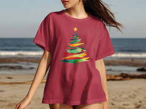 Maroon t-shirt with colorful watercolor Christmas tree graphic on chest.