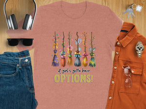 Pink t-shirt with cartoon brooms and text "A girl's gotta have OPTIONS!".