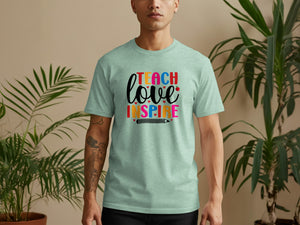 Light green t-shirt with "TEACH love INSPIRE" text in colorful letters and a pencil graphic.