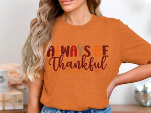 Orange t-shirt with "ALWAYS BE Thankful" text and fall leaves design.