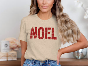 Light beige t-shirt with red "NOEL" text in distressed font.