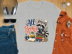 Gray t-shirt with "All Booked" text and a raccoon sitting on books.