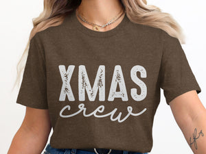 Brown t-shirt with white "XMAS crew" graphic and layered necklaces.