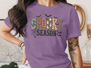 Purple t-shirt with "Spooky Season" text in Halloween-themed letters.