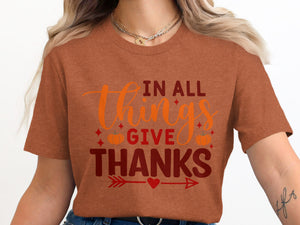 Brown t-shirt with "In All Things Give Thanks" text and autumn graphics.