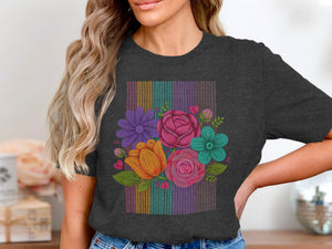 Dark grey t-shirt front with a colorful knit floral bouquet on a striped background.