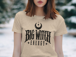 Beige t-shirt with "Big Witch Energy" text and crescent moon graphic.