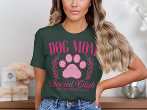 Dark green t-shirt with pink "DOG MOM Social Club LIFE IS BETTER WITH A DOG" graphic.