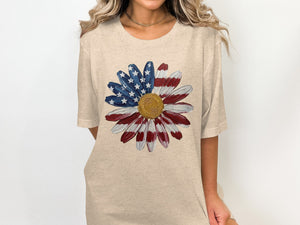 Tan t-shirt with a daisy design painted like the American flag.