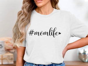 White t-shirt with "#momlife" graphic and heart accent.