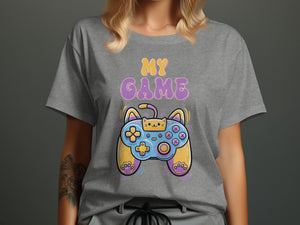 Grey t-shirt featuring text "MY GAME" and a cartoon cat video game controller.