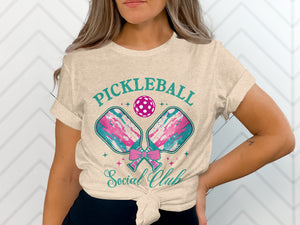 Pickleball Social Club text with pickleball paddles, ball, and pink bow graphic.
