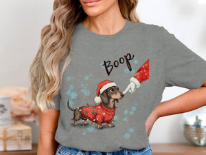 Dachshund in Christmas sweater and hat with lights, Santa's finger booping nose.