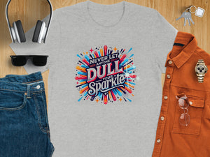 Grey t-shirt with colorful "Never Let Anyone Dull Your Sparkle" graphic.