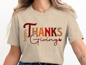 Happy Thanks Giving text graphic on a tan t-shirt worn by a woman.