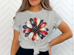 Grey t-shirt with a patriotic flower graphic featuring red, white, and blue petals.