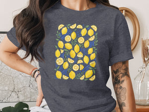 T-shirt with a repeating pattern of yellow lemons and green leaves.