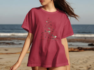 Red t-shirt with a sketched Christmas tree design featuring ornaments and holly.