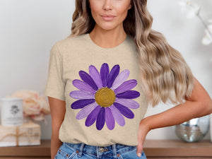Beige t-shirt with a painted purple daisy graphic and gold center.
