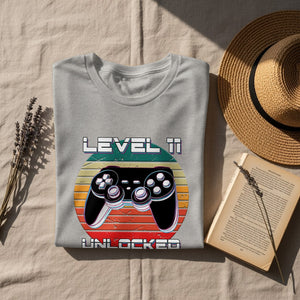 Gray t-shirt with 'Level 11 Unlocked' and a video game controller graphic.