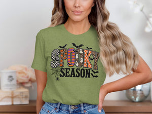Green t-shirt with "SPOOKY SEASON" text featuring Halloween patterns and bats.