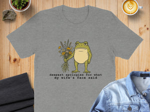 Grey t-shirt with a frog holding flowers and text.