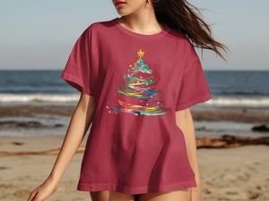 Maroon t-shirt with colorful abstract Christmas tree graphic and yellow star.