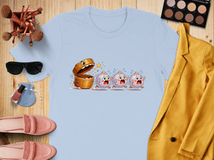 Light blue t-shirt with cartoon dim sum characters running from an open bamboo steamer.