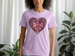 Pink t-shirt with a bold graphic of a pencil inside a leopard print heart adorned with a bow.