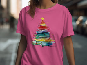 Pink t-shirt with a watercolor Christmas tree design featuring a yellow star.