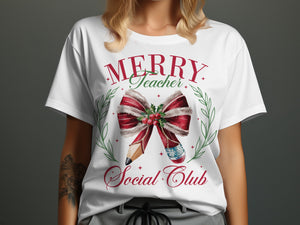 White t-shirt with "Merry Teacher Social Club" text and Christmas-themed pencil and candy cane design.