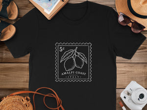Black t-shirt with stamp design of lemons, "Amalfi Coast," and "Italy" text.