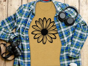 Gold t-shirt with black daisy graphic, open plaid shirt, headphones, and camera.