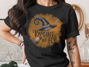 Black t-shirt with witch hat and broom graphic reading "TONIGHT WE FLY."