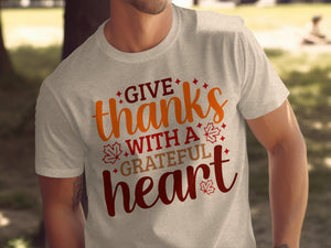 Light gray t-shirt with "GIVE thanks WITH A GRATEFUL heart" text and autumn leaves.