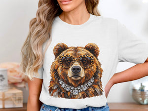 Brown bear wearing leopard print sunglasses and a diamond necklace on a white t-shirt.