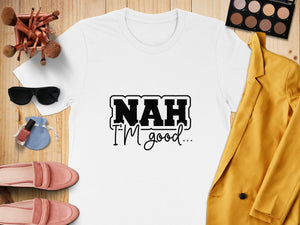 White t-shirt with "NAH I'M good..." text, flat lay with makeup and fashion items.
