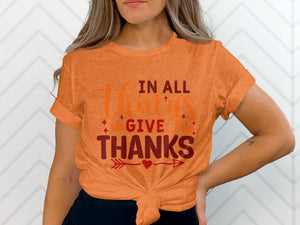 Orange t-shirt with text "In All Things Give Thanks" and pumpkins.