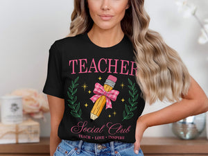 Black t-shirt with pink text reading "TEACHER Social Club Teach Love Inspire."