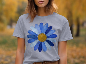 Grey t-shirt with blue and white painted flower design and gold center.