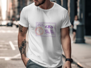 White t-shirt with purple and orange stamp graphic of beach chairs and umbrella.