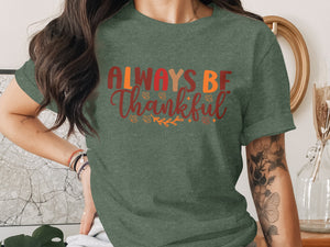 Green t-shirt with "ALWAYS BE Thankful" text and autumn leaves graphics.