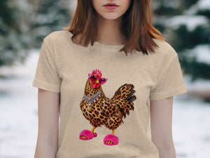 Leopard print rooster graphic wearing pink sunglasses and fluffy slippers on a t-shirt.