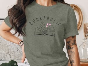 Green t-shirt with "BOOKAHOLIC" text and open book graphic with flowers.