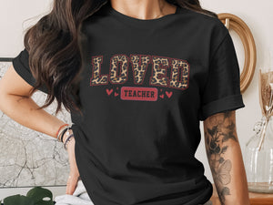 Black t-shirt with leopard print "LOVED TEACHER" text and hearts.